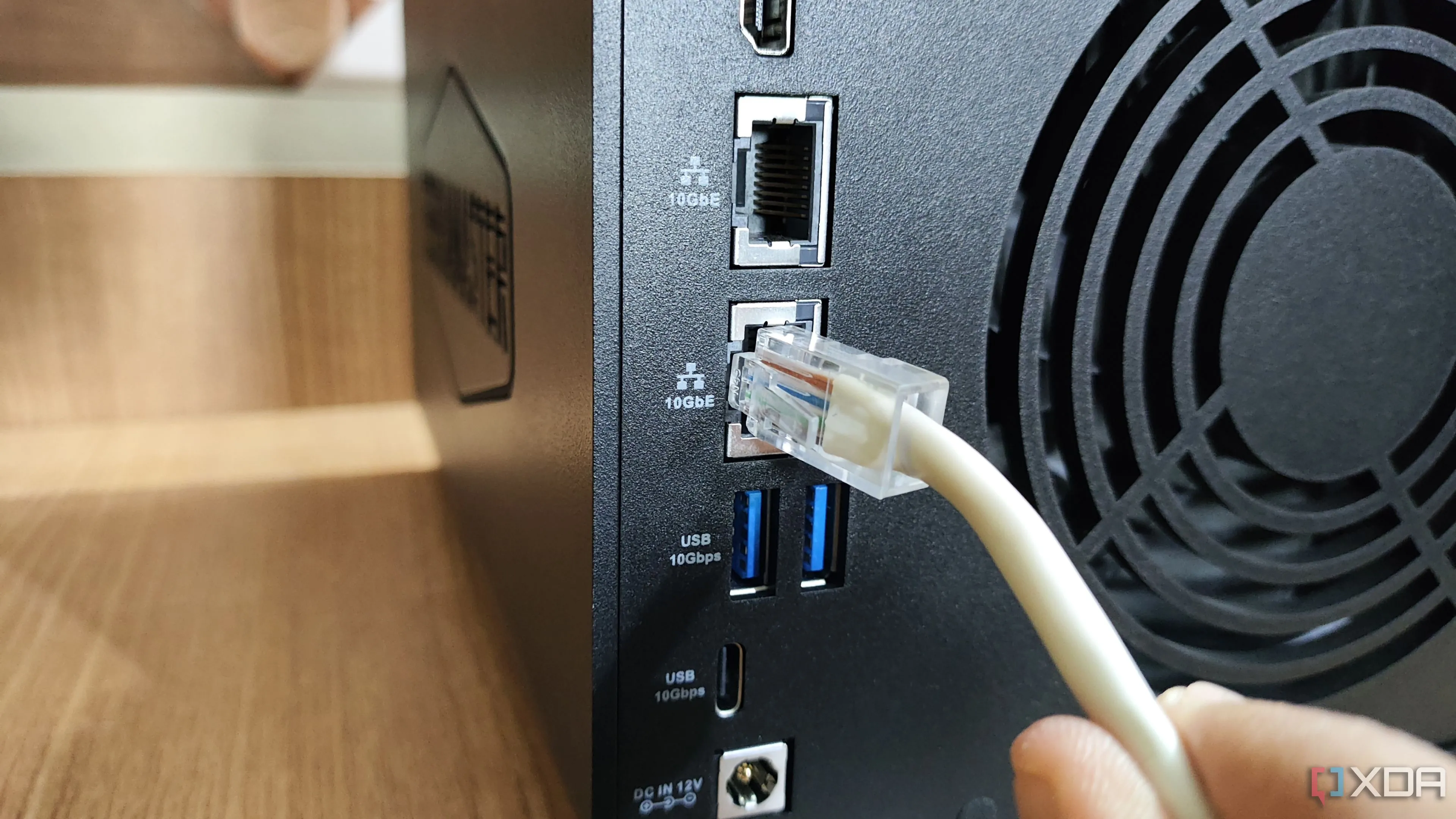 Cắm cáp Ethernet vào cổng LAN 10GbE trên NAS TerraMaster F4-424 Max, liên quan đến kết nối mạng và hiệu quả hoạt động của NAS