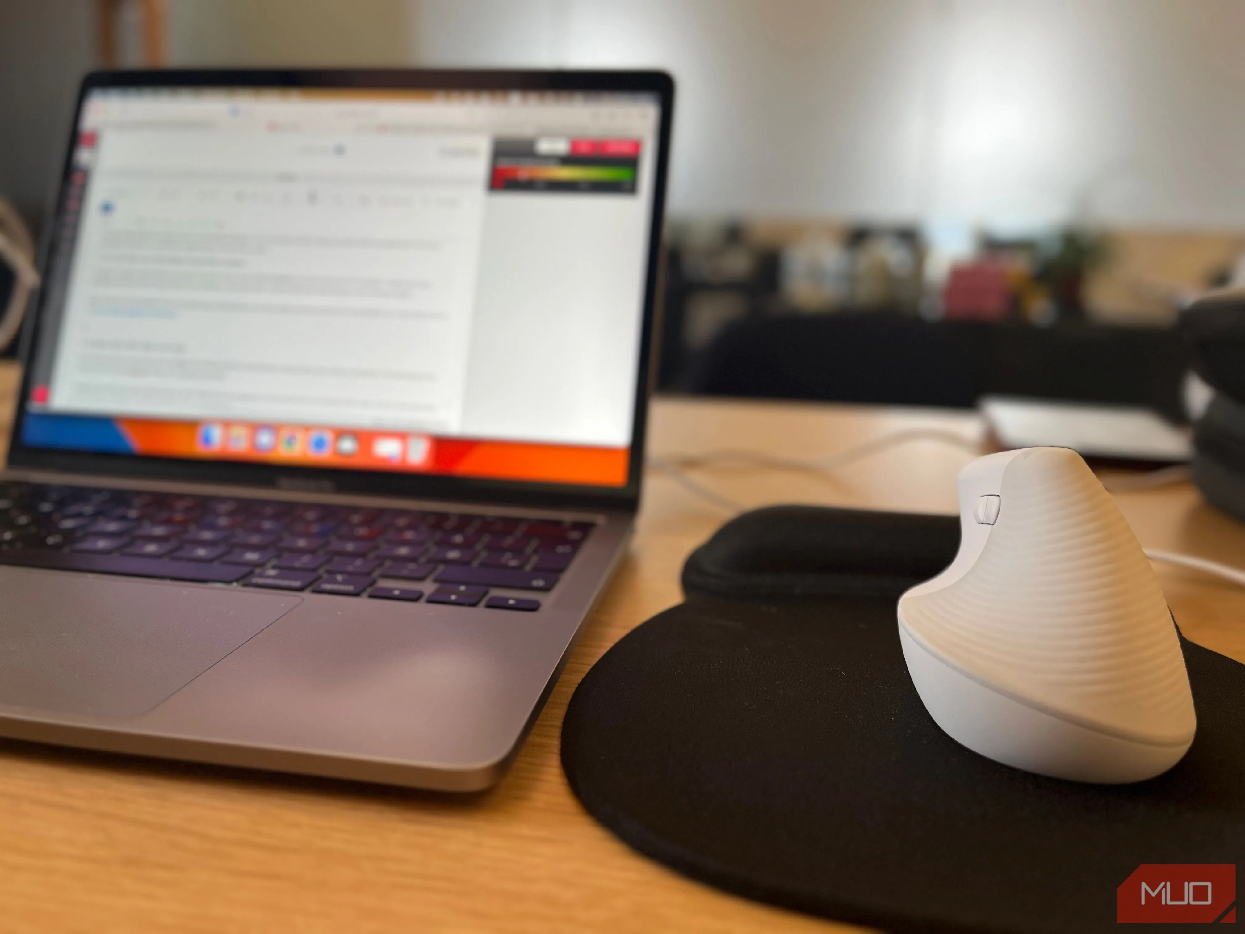 Chuột không dây màu xám trên bàn làm việc tại không gian coworking, thể hiện sự tiện lợi khi di chuyển và làm việc linh hoạt.